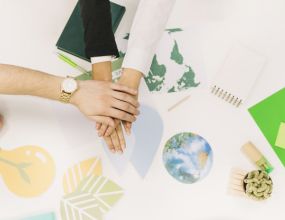 Group-businesspeople-stacking-their-hands-desk 10